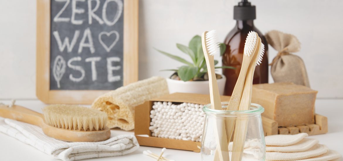 Zero waste, Recycling, Sustainable lifestyle concept. Eco-friendly bathroom accessories: toothbrushes, reusable cotton make up removal pads, make up remover in a glass container, natural brushes, handmade soap, bamboo ear sticks